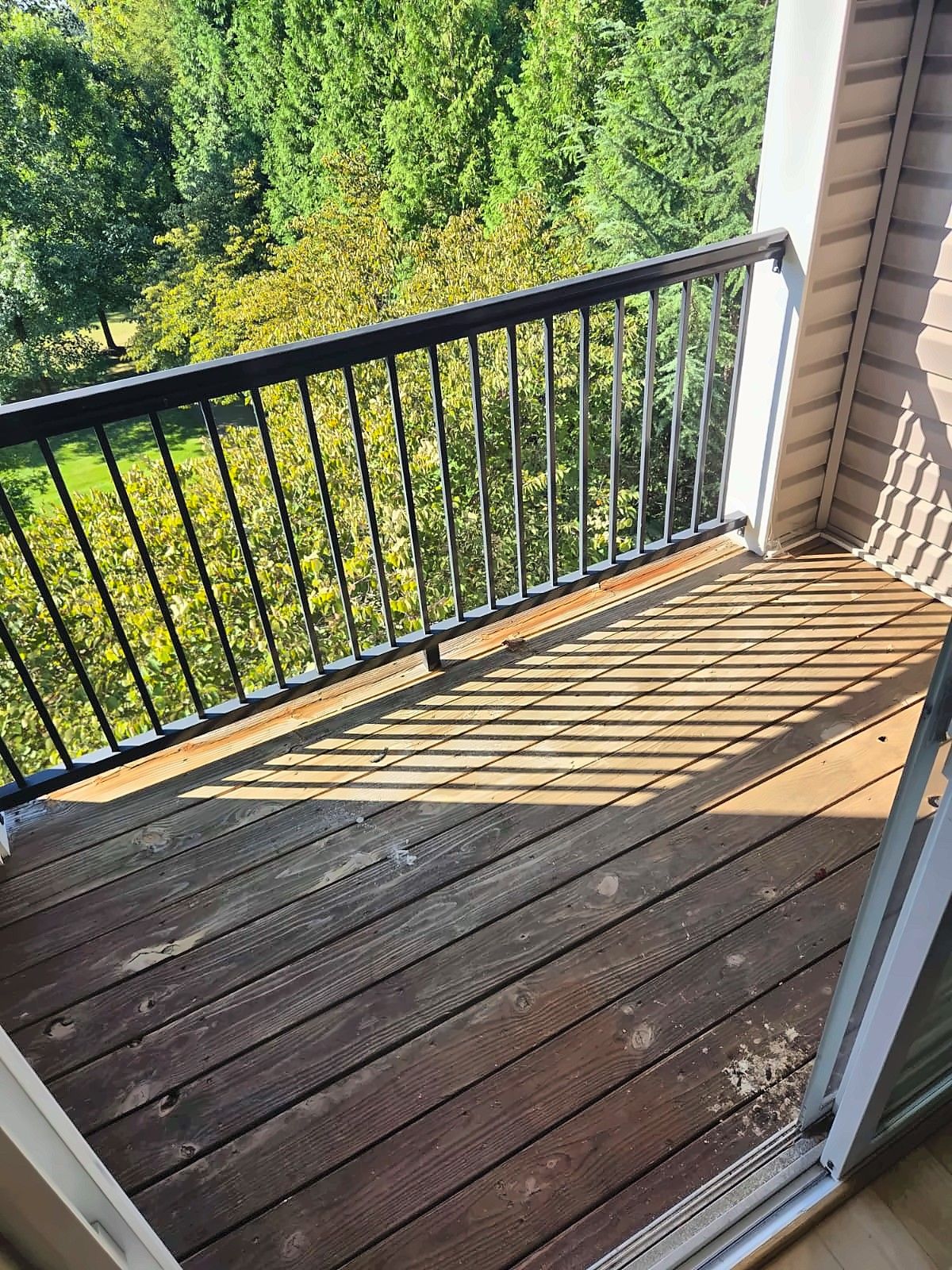 Weathered balcony deck boards before replacement