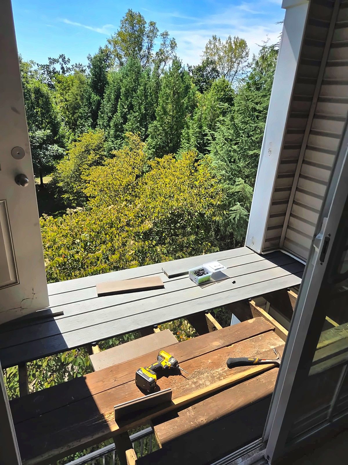 New gray composite boards being installed on a balcony