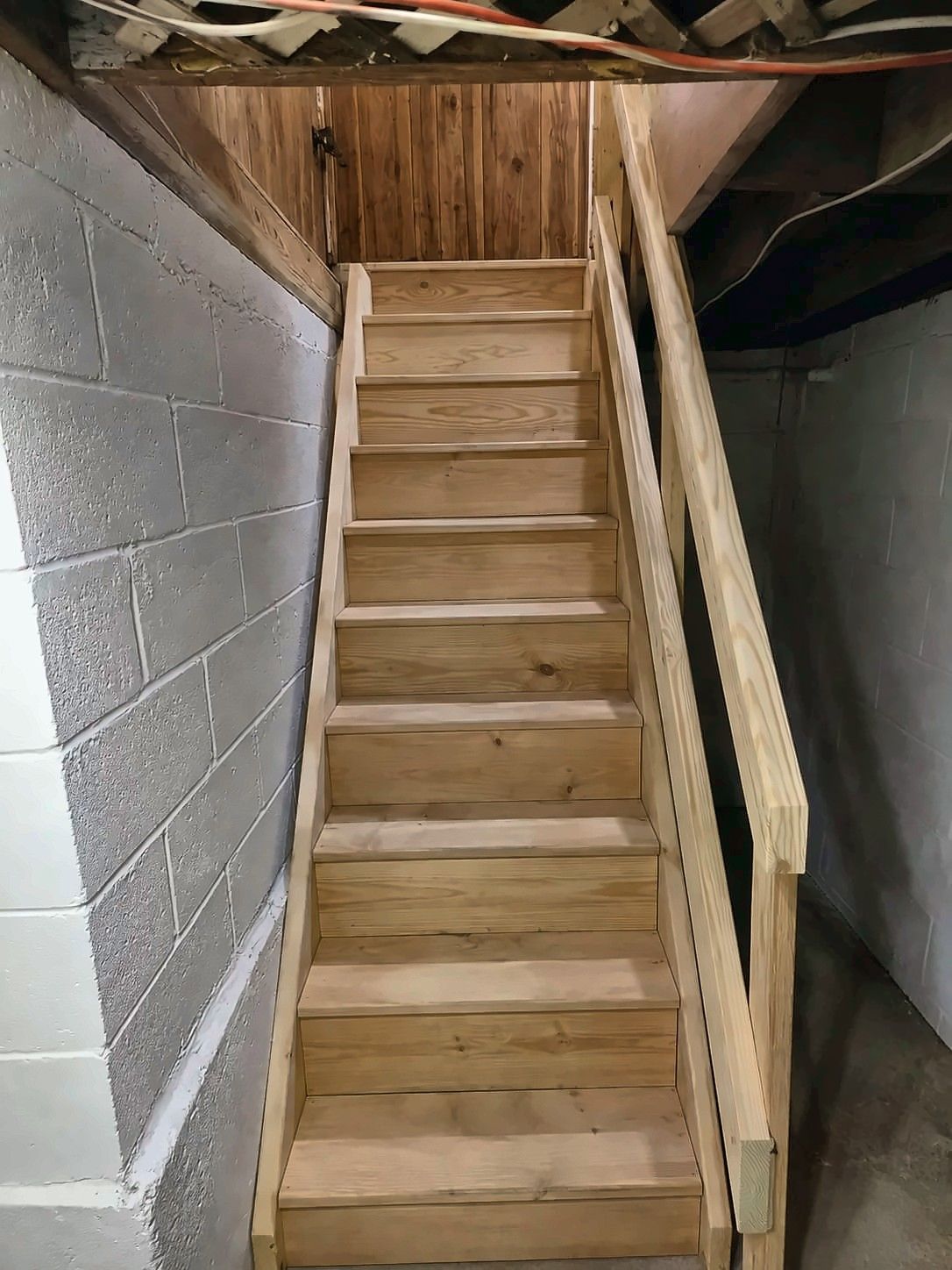 New wood basement staircase with handrail