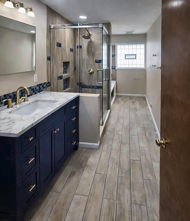 After: Before and after of a bathroom remodel with navy vanity