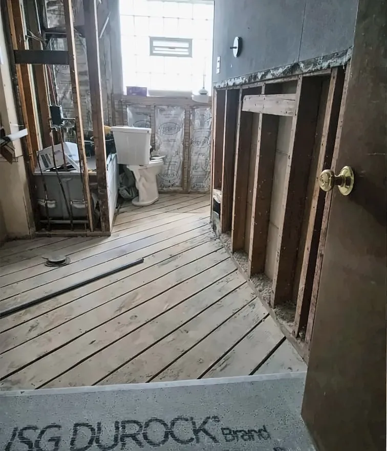 Before: Before and after of a bathroom remodel with navy vanity