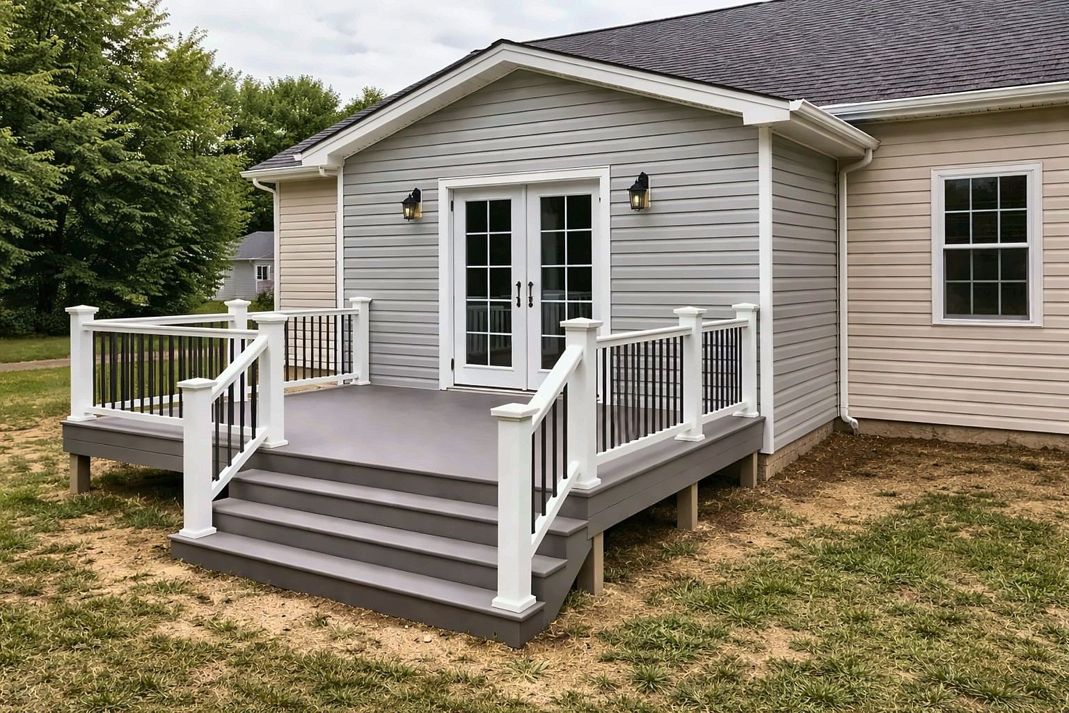 New composite deck with white railings off French doors