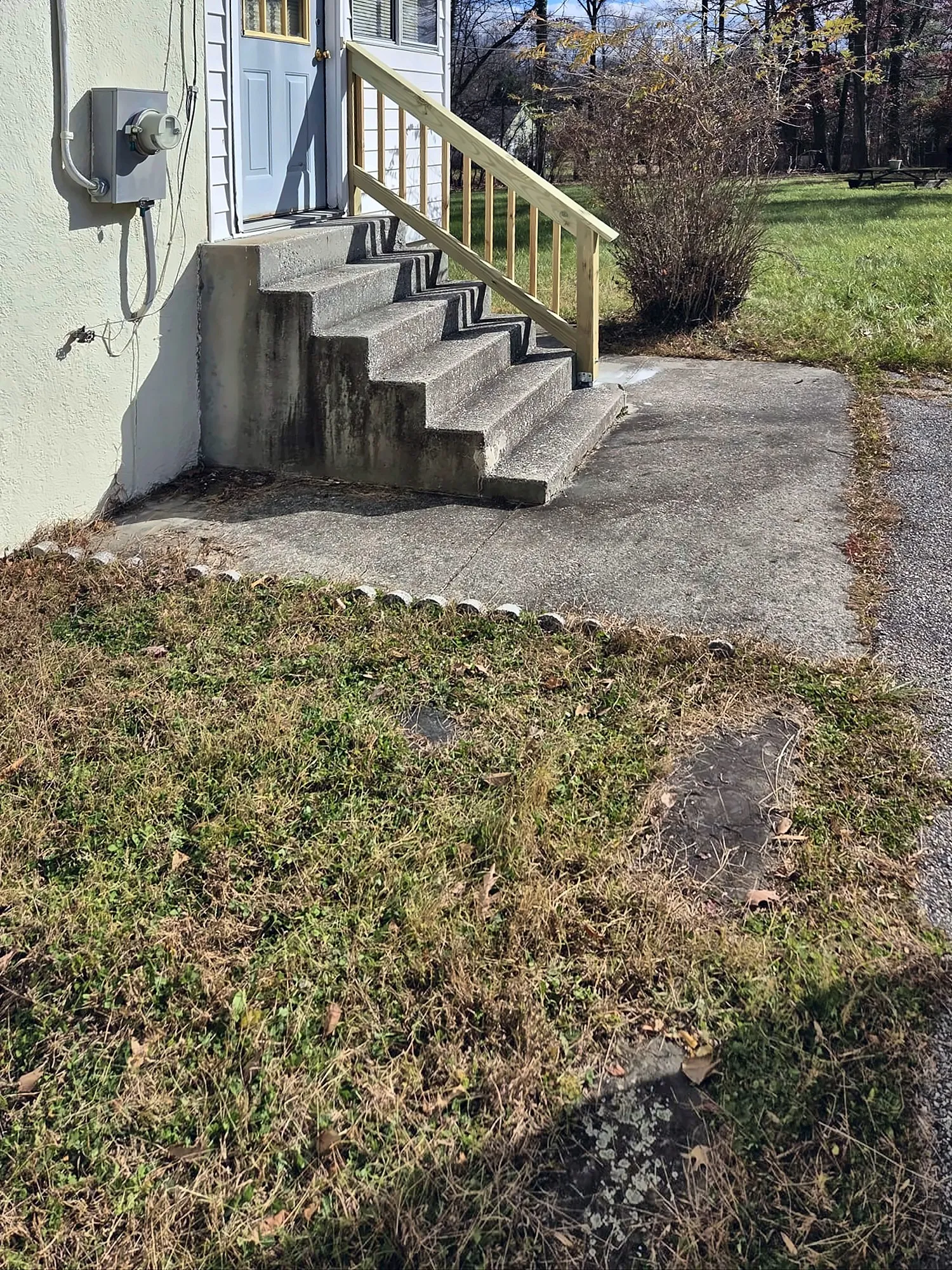 Concrete back steps with new wood railing