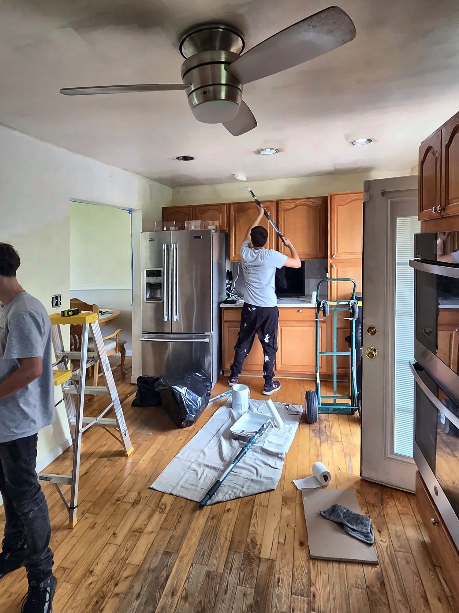 Painters prepping and painting a kitchen