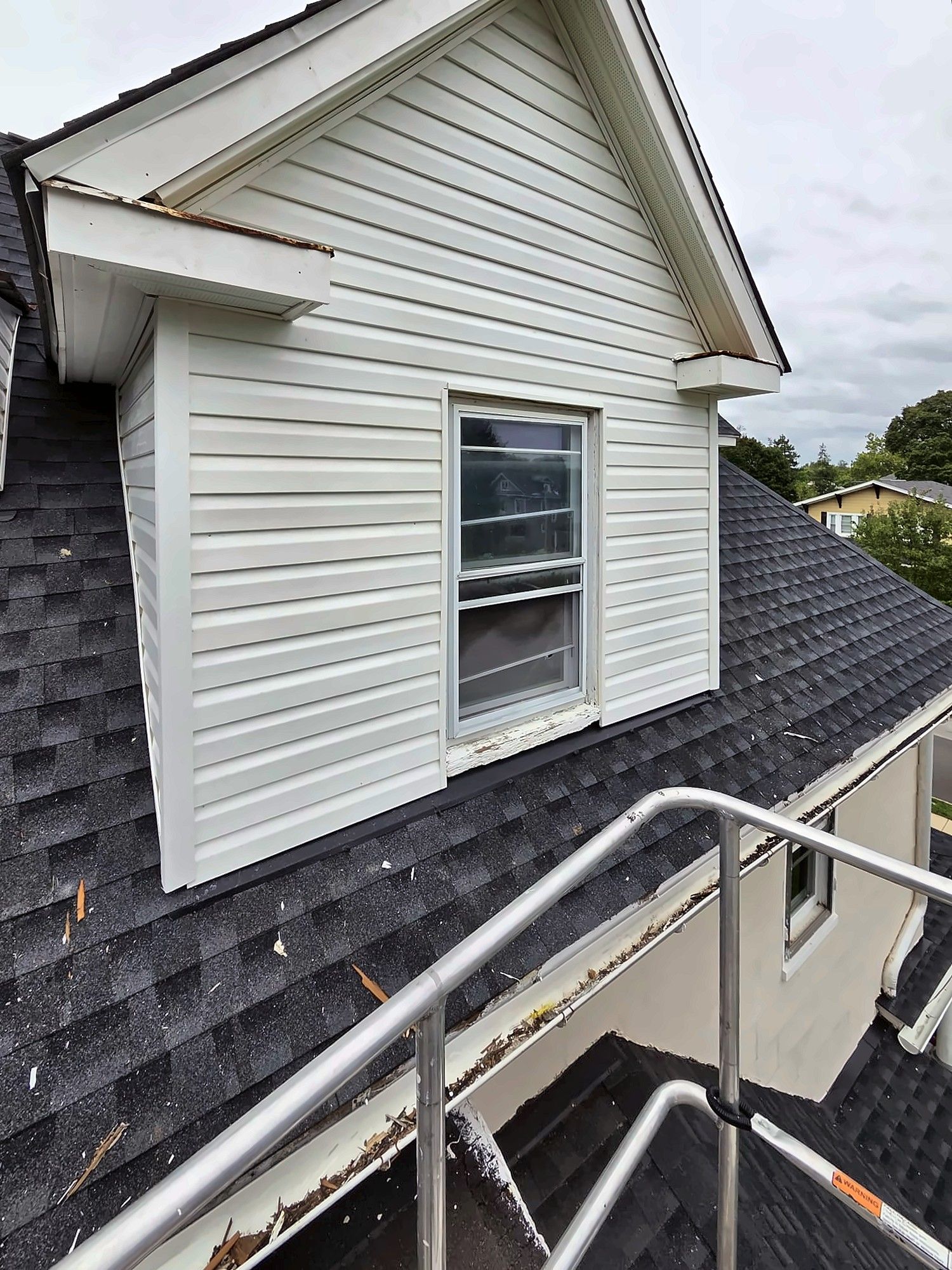 Roof dormer with new white vinyl siding