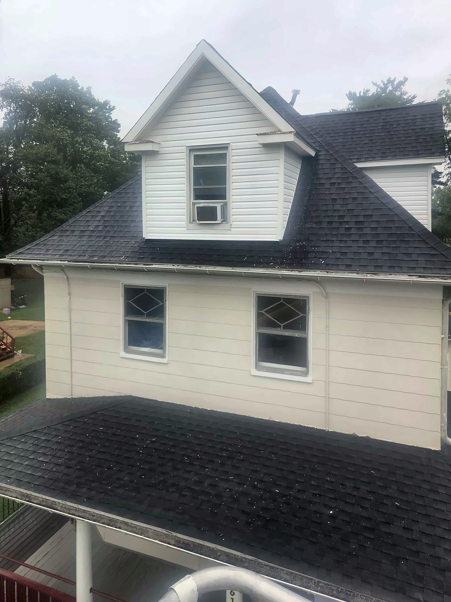 Rear dormer and upper wall with white siding