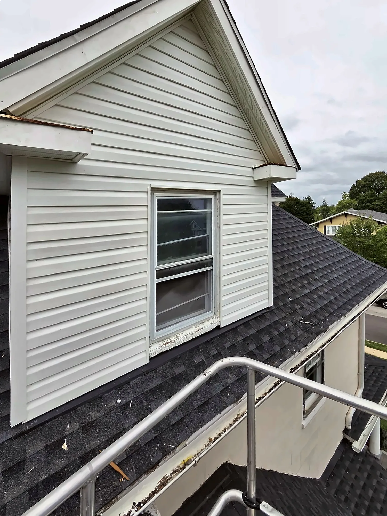 Dormer with white vinyl siding, alternate angle