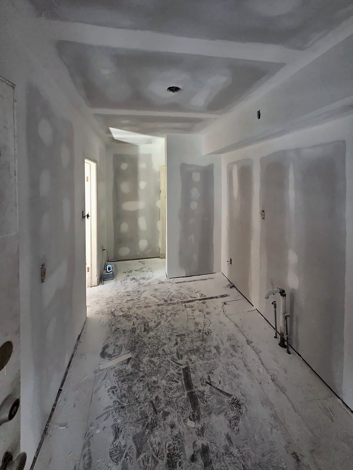 New drywall taped and mudded in a hallway