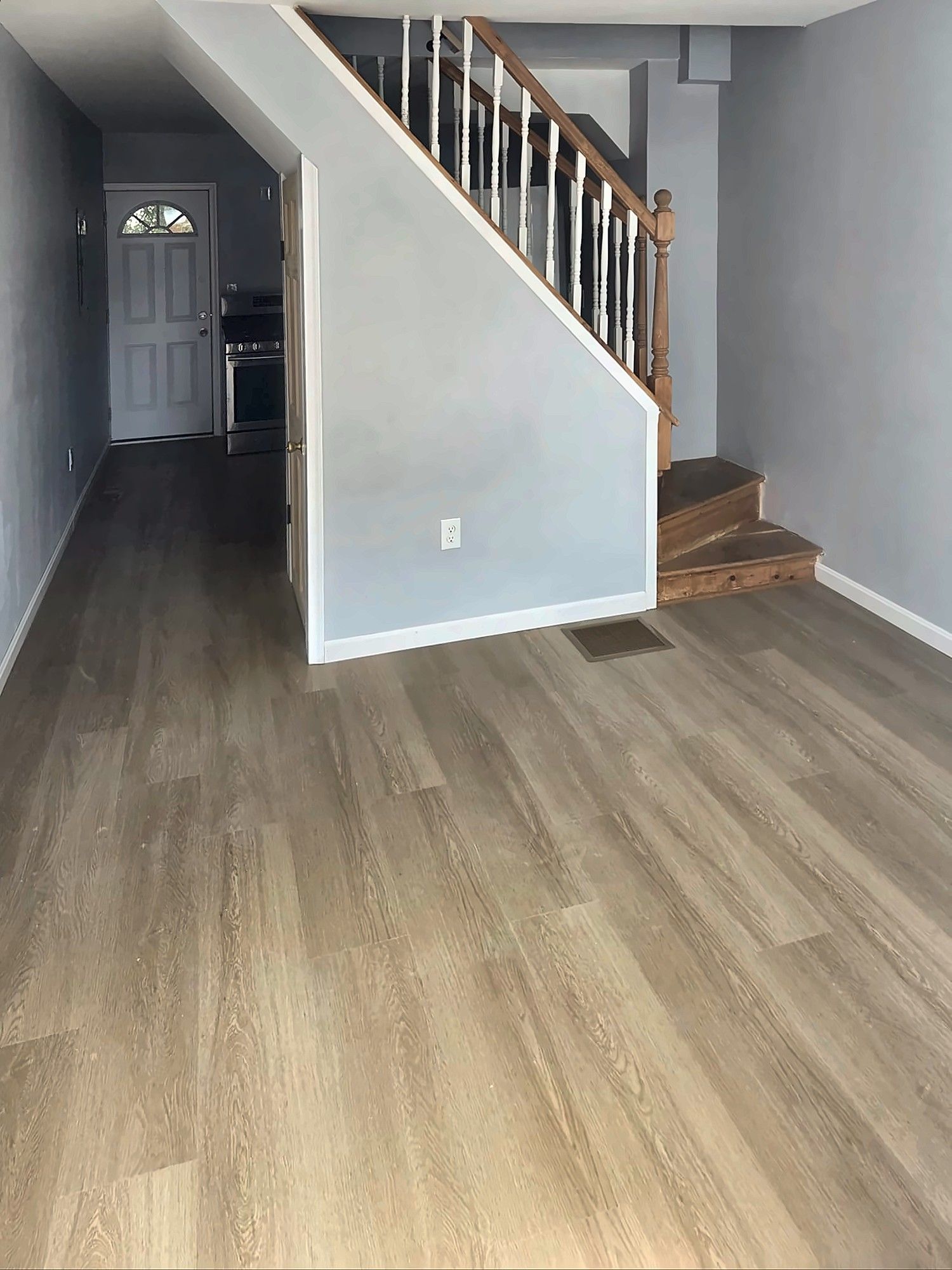 Renovated entry hall with staircase and vinyl plank floor