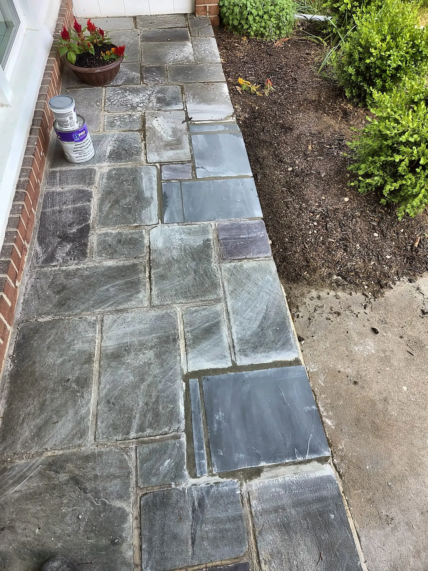 New flagstone walkway beside a garden bed