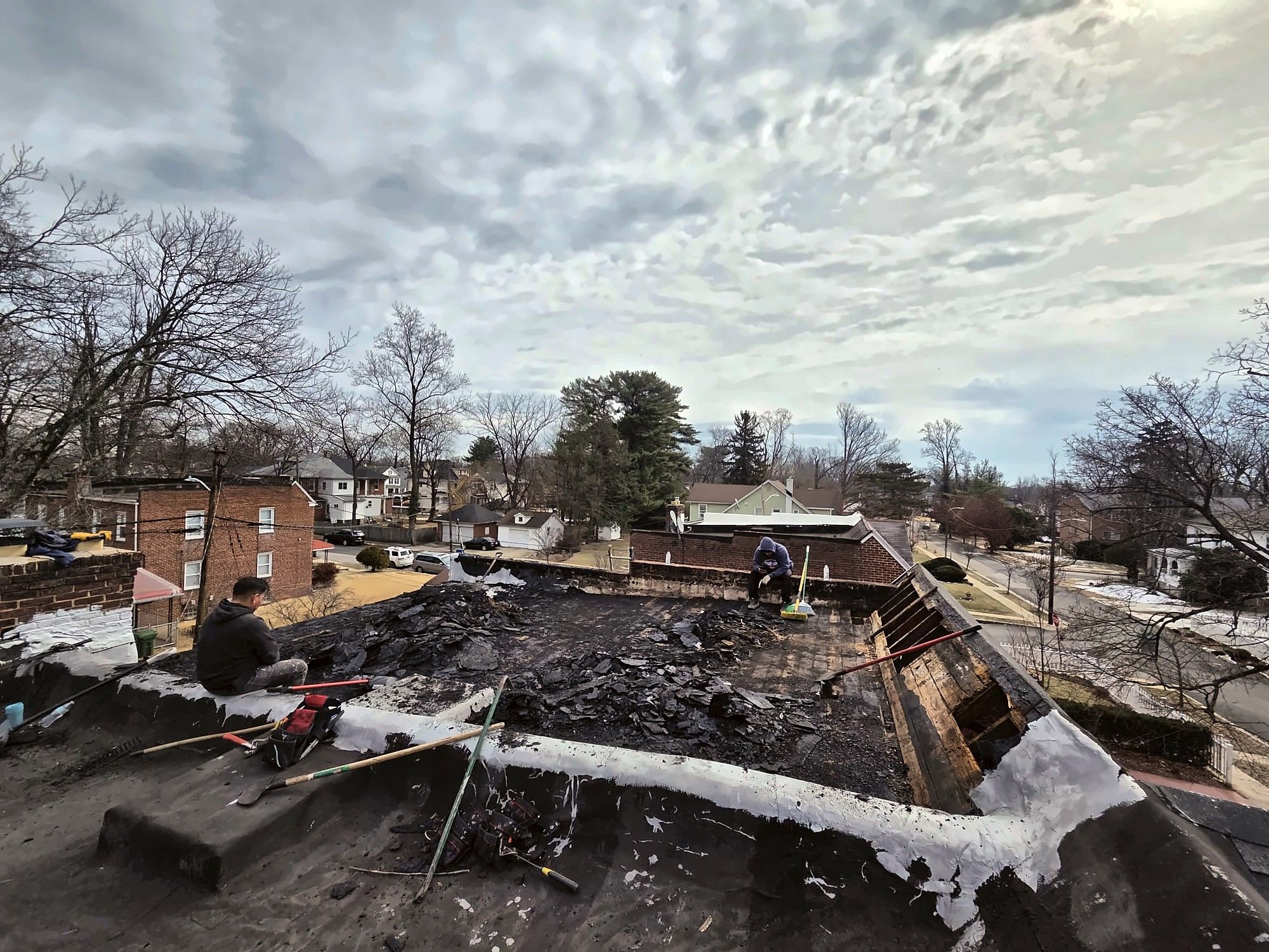 Crew removing an old flat roof