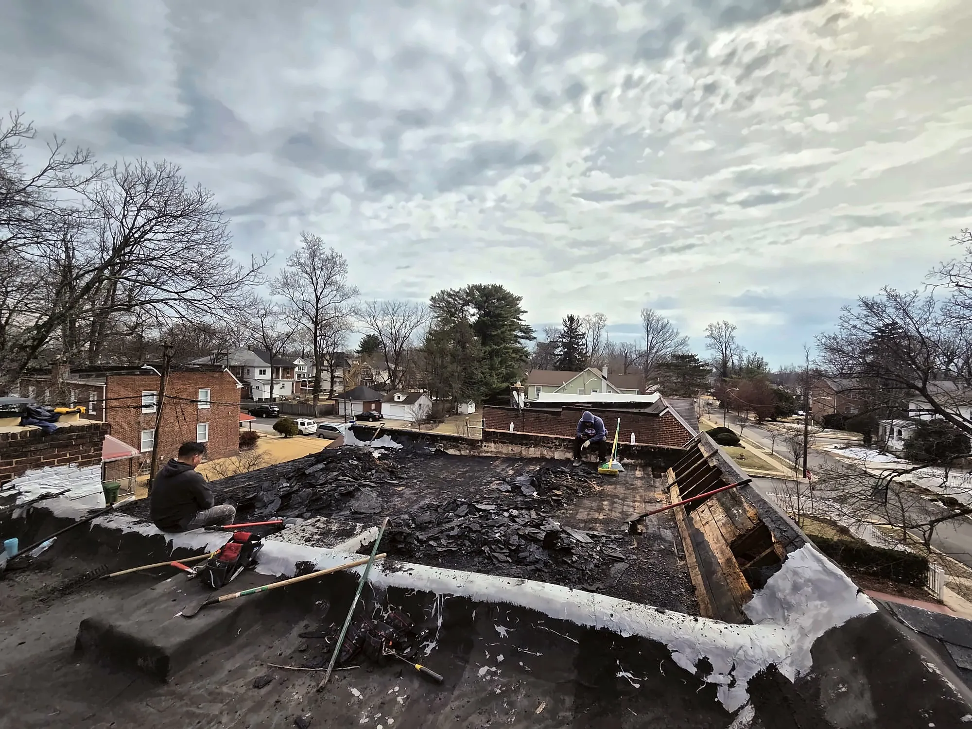 Crew removing an old flat roof