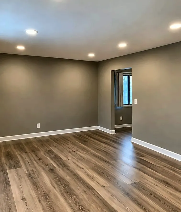 After: Before and after living room renovation with new flooring and recessed lights