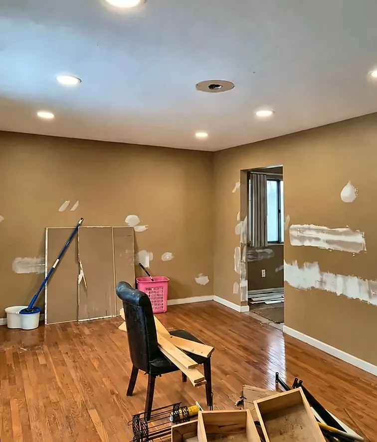 Before: Before and after living room renovation with new flooring and recessed lights