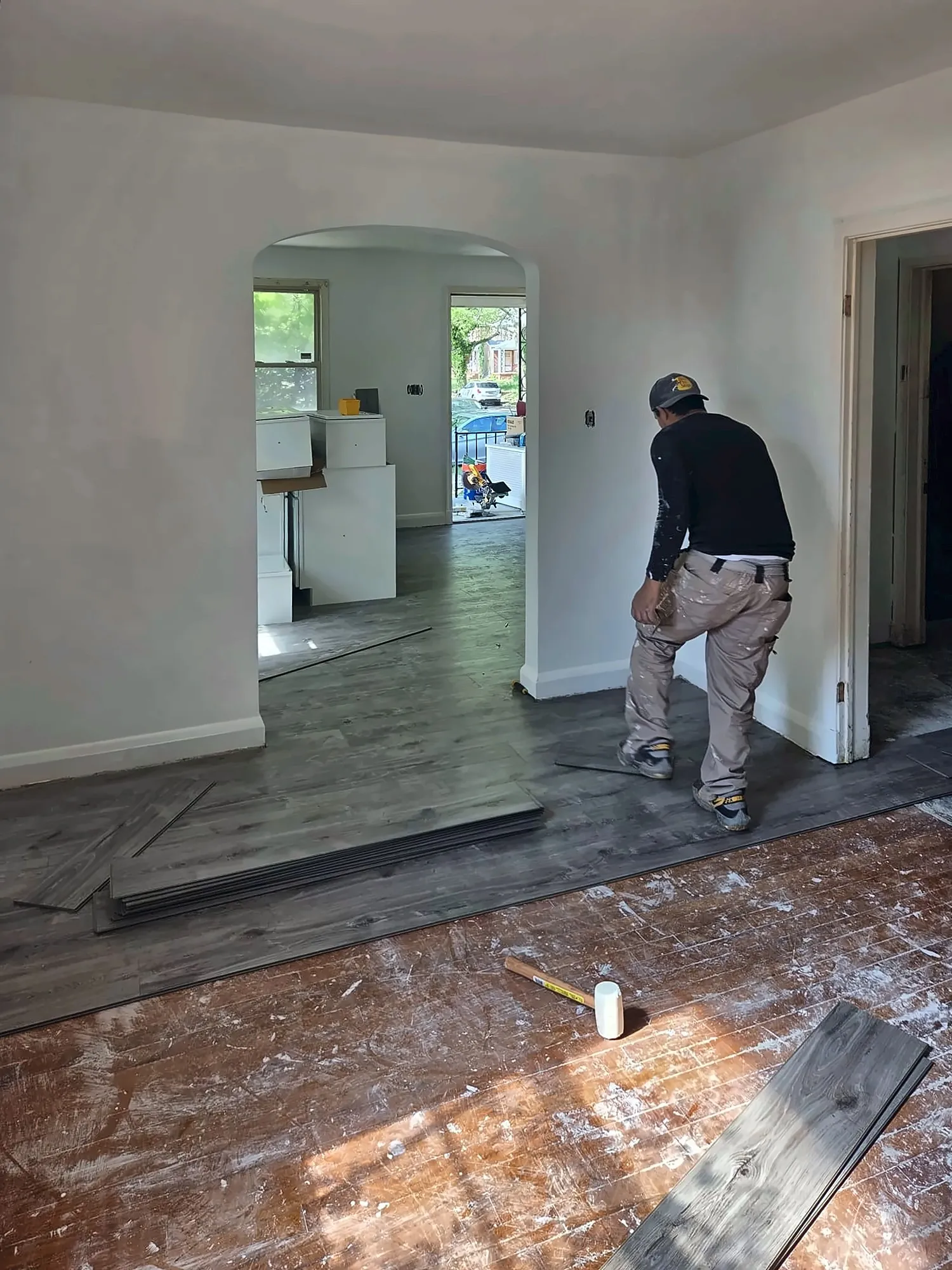 Installer laying vinyl plank flooring