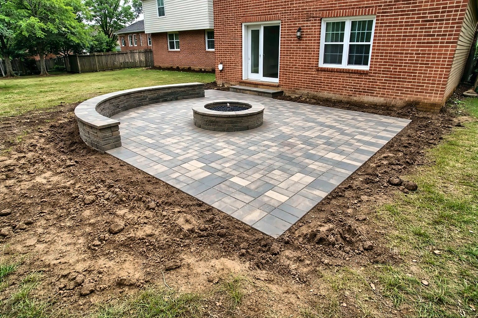 New paver patio with fire pit and seating wall