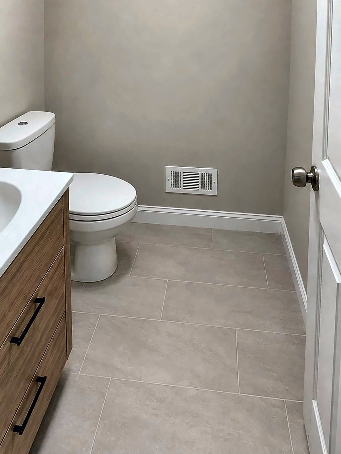Remodeled powder room with wood vanity
