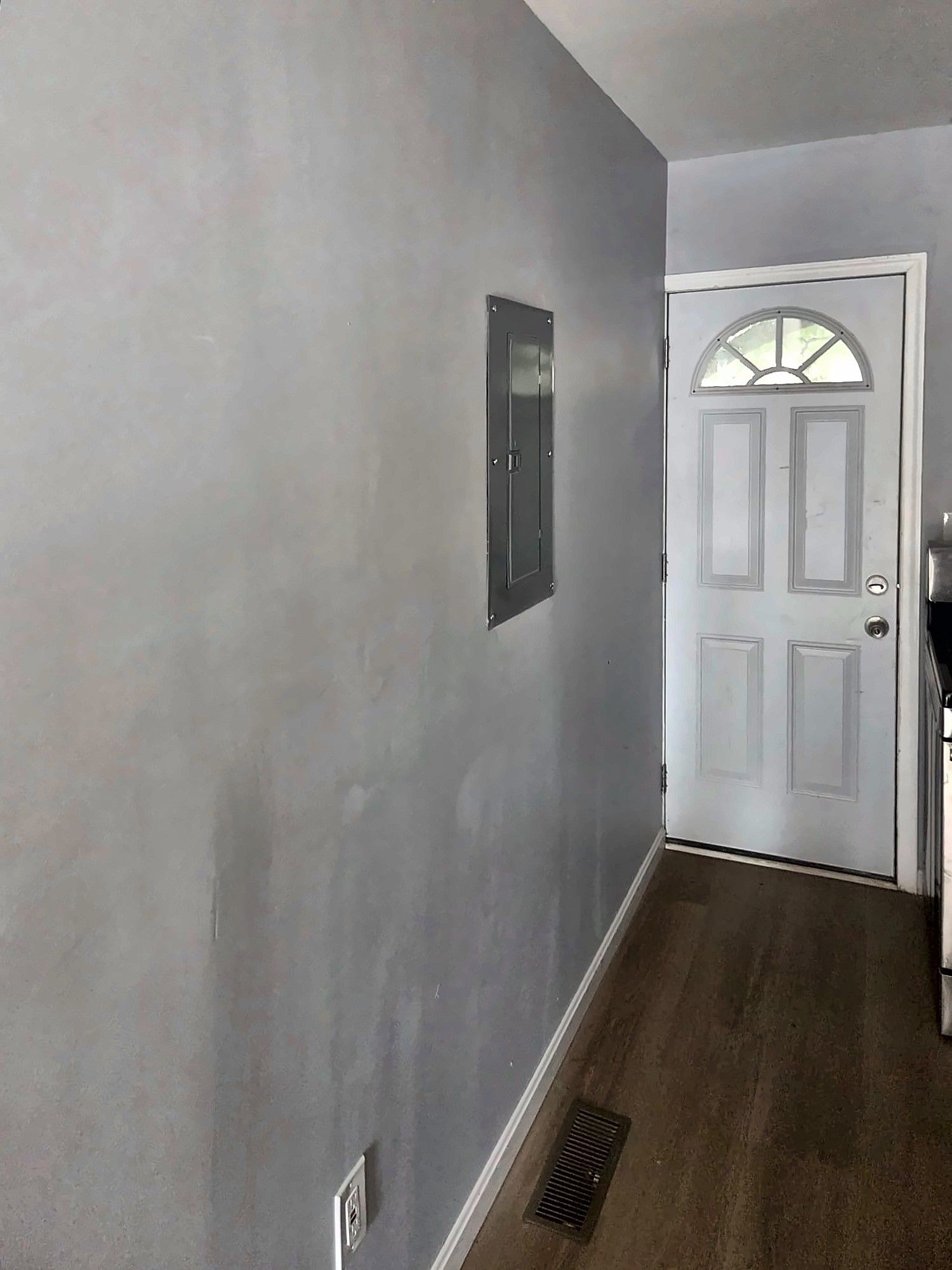 Renovated hallway with new flooring leading to back door