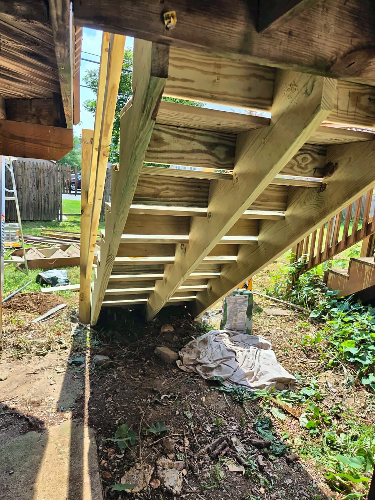 Underside of new wood rear stairs showing the framing