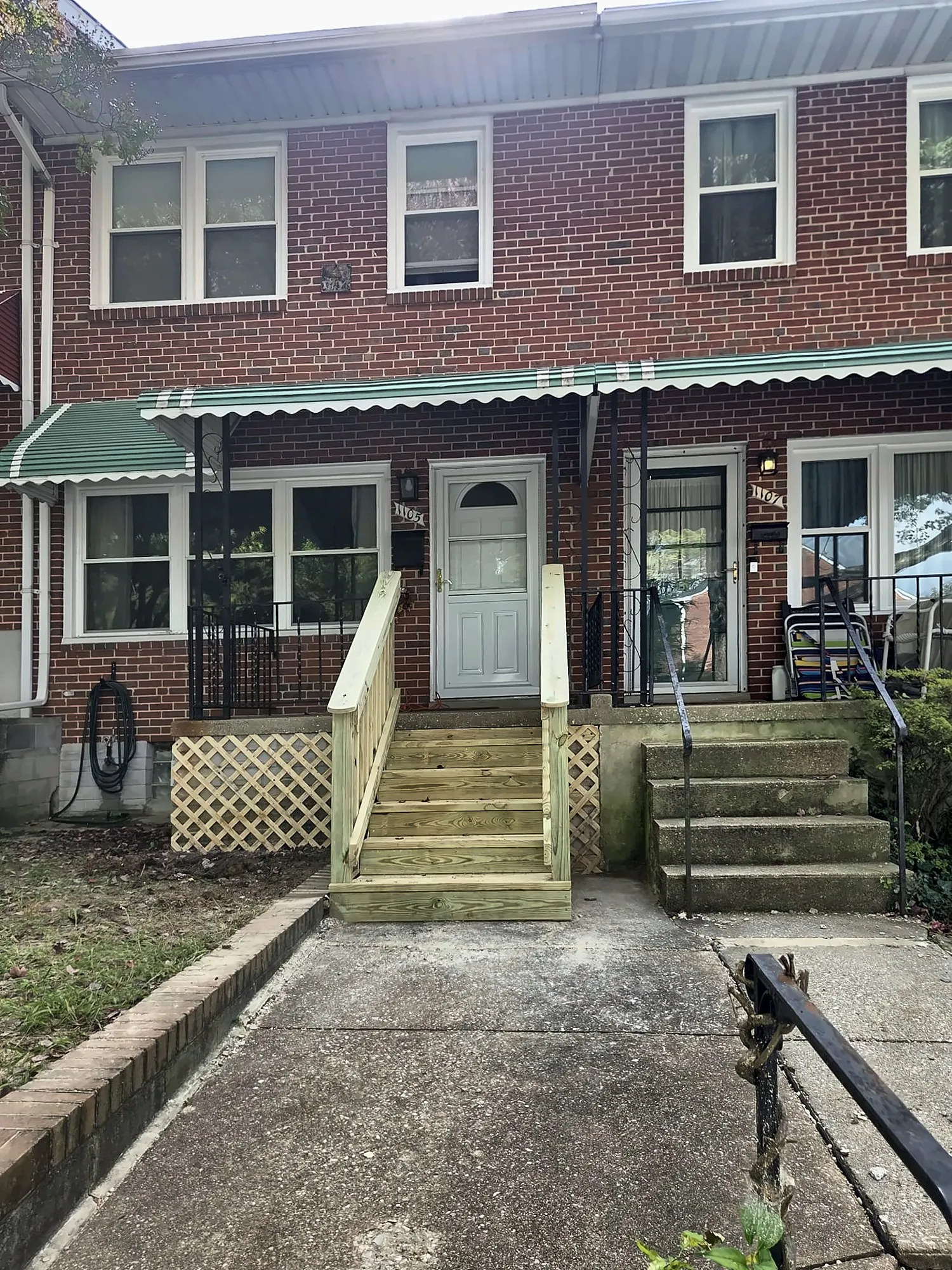 Brick rowhouse with new wood front steps