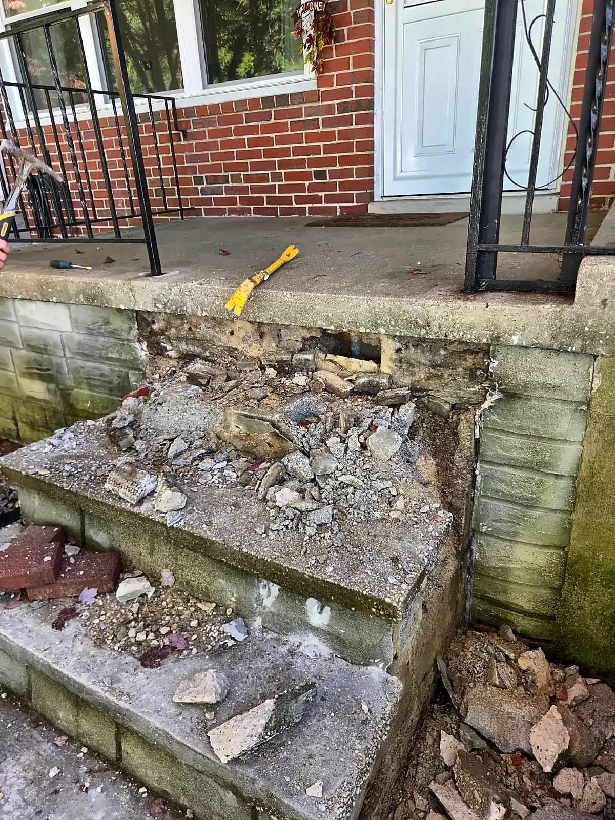 Broken-out concrete front steps before rebuilding
