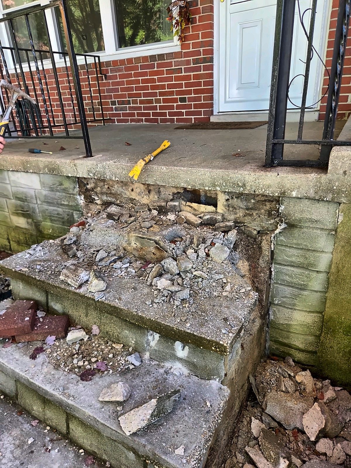 Broken-out concrete front steps before rebuilding