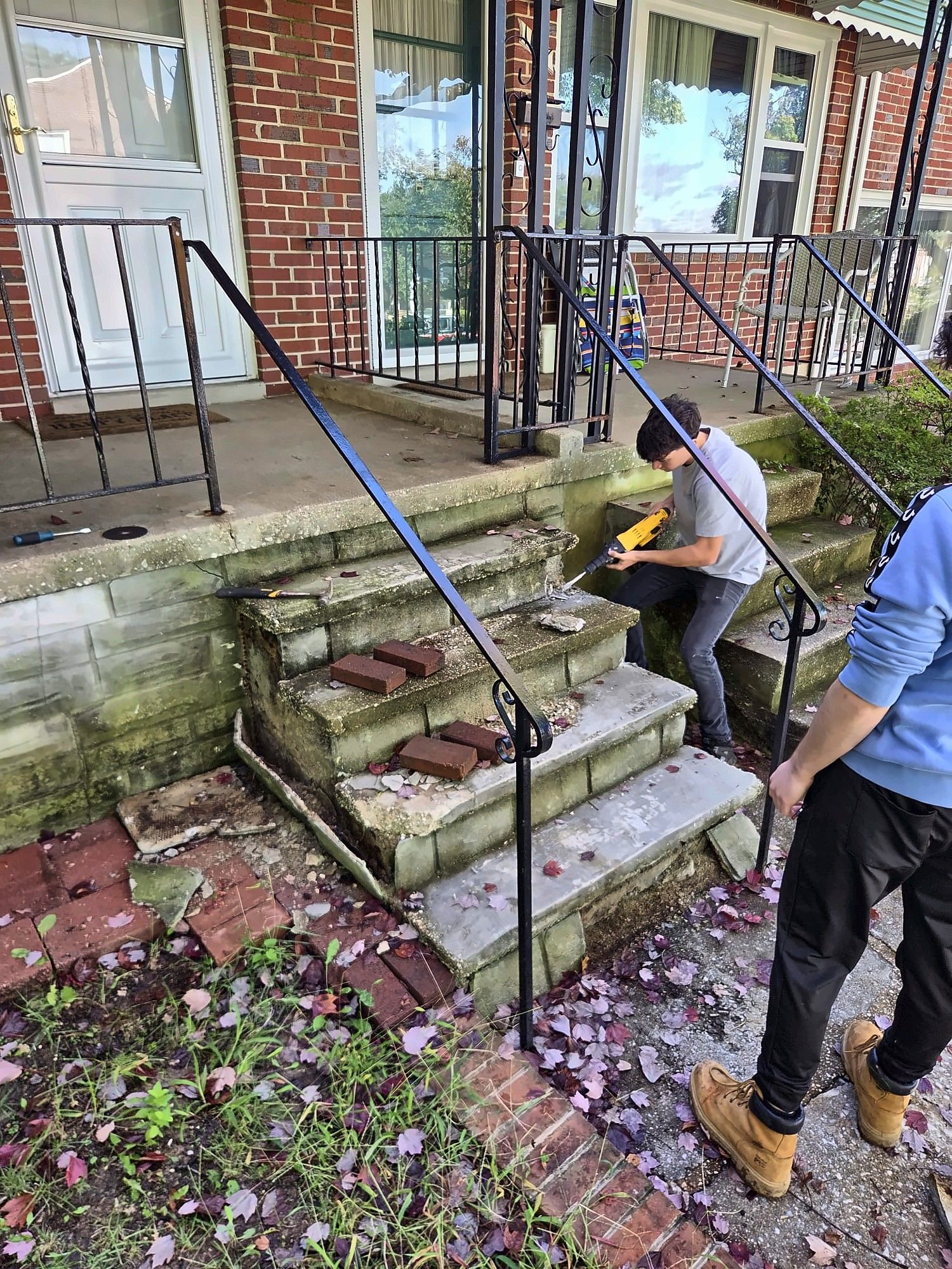 Crew removing old brick and concrete front steps