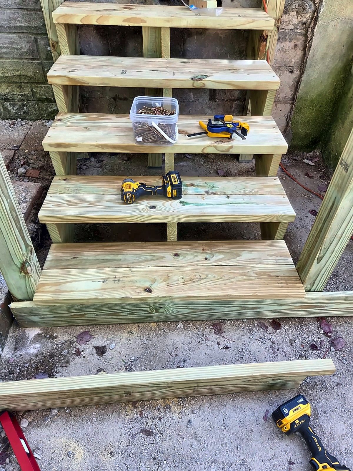 New pressure-treated front step treads under construction
