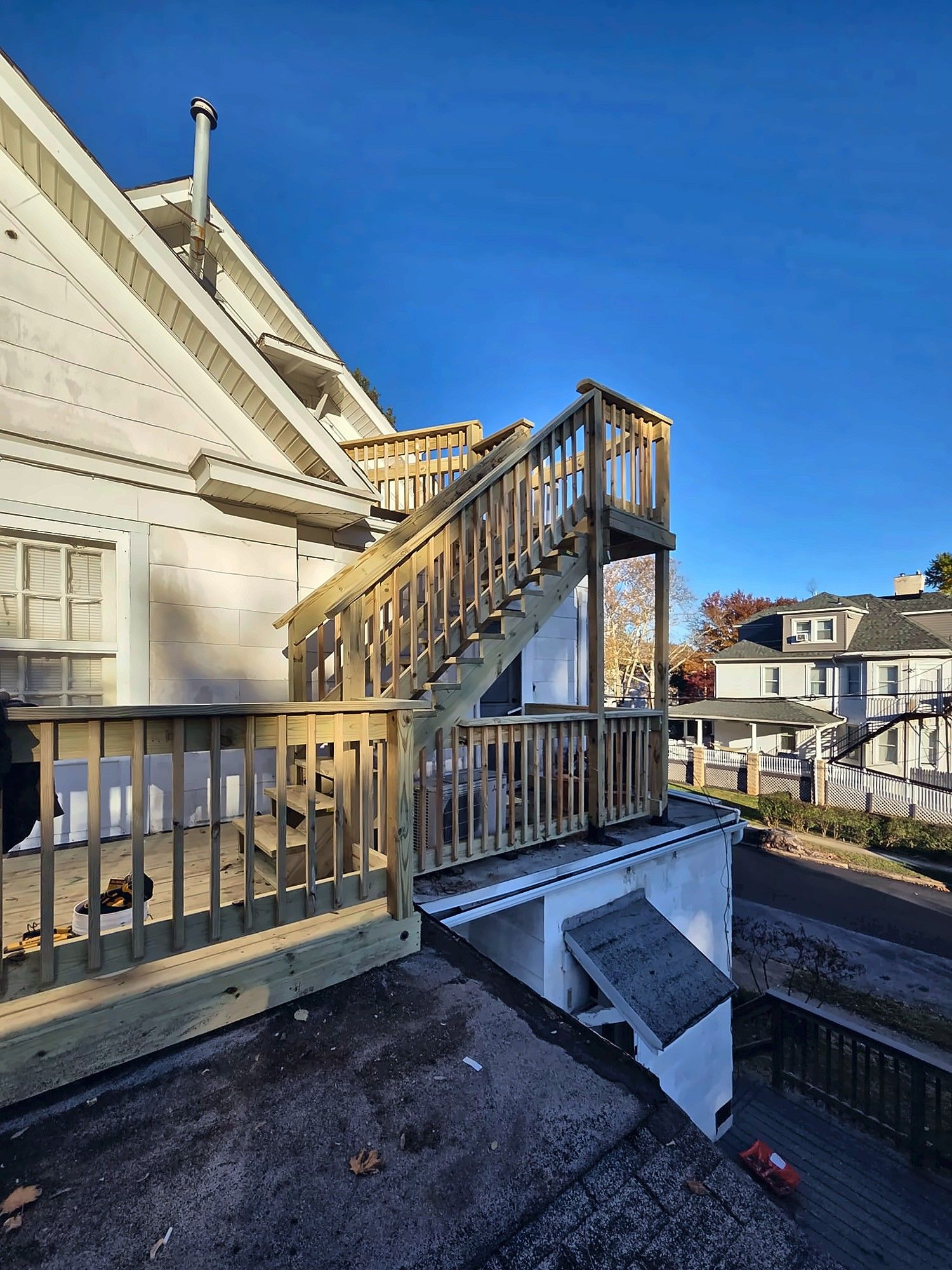 Second-story deck and stairs on a white house