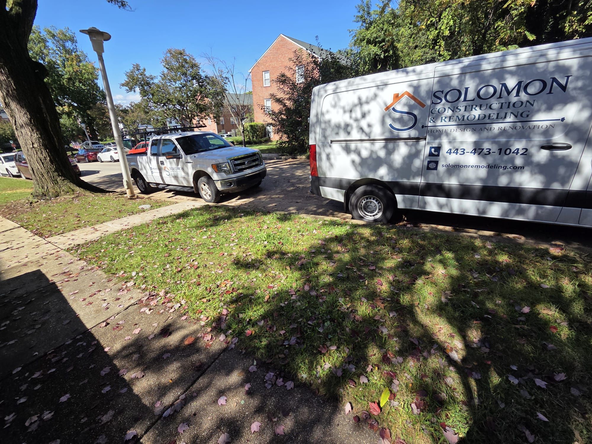 Solomon Construction & Remodeling work van and truck at a job site