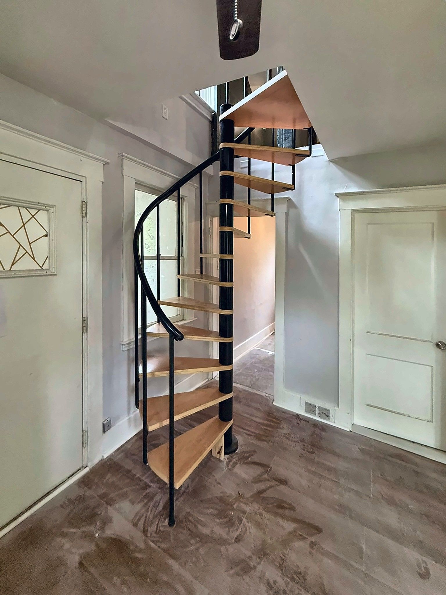 Black metal spiral staircase with wood treads